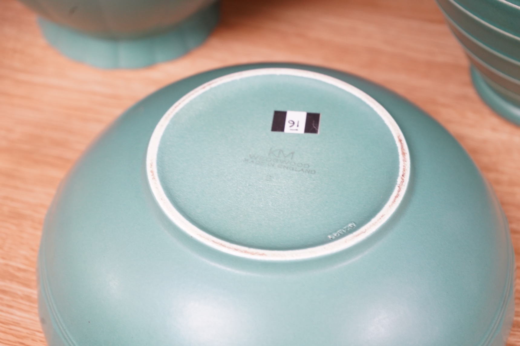 Keith Murray for Wedgwood, three green glazed bowls to include a ribbed example, largest 24cm in diameter